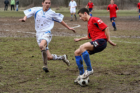 two male play soccer on field thumbnail