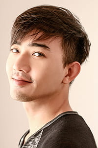 pixie-cut man wearing black and gray top thumbnail