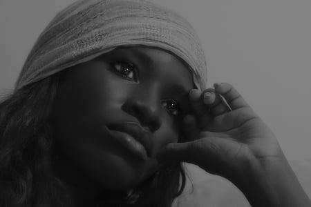 grayscale photo of woman putting her hand on her left cheek thumbnail