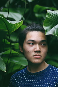 man surrounded by green leaf thumbnail