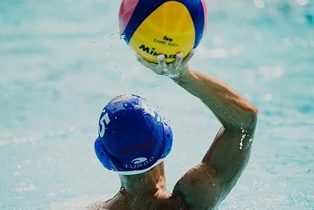 swimmer about to throw ball on body of water thumbnail