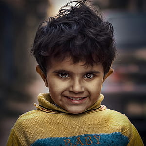 closeup photo of smiling boy wearing yellow turtleneck sweater thumbnail