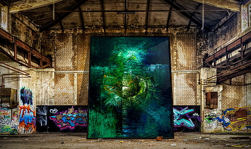 several paintings leaning on rusted building thumbnail