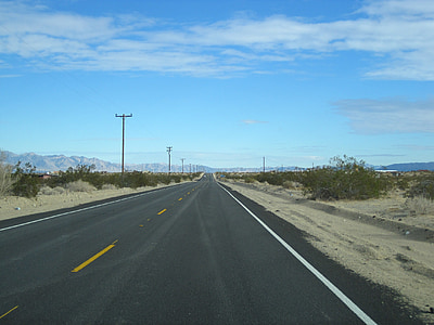 gray concrete road near dusty ground at daytime thumbnail