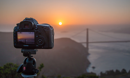 black Canon DSLR camera on tripod stand thumbnail