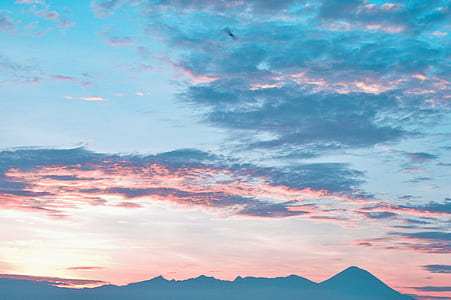 view of clear blue sky during sunset with silhouette mountain thumbnail