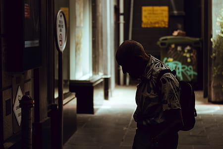 person standing in front of street signage thumbnail