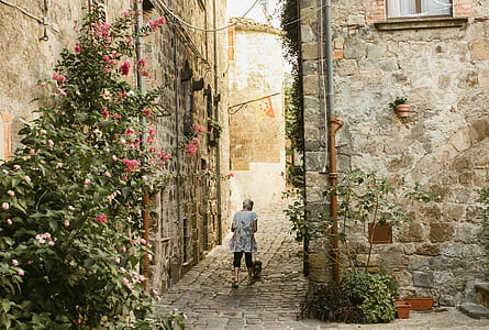woman walking in hallway surrounded by flowers thumbnail