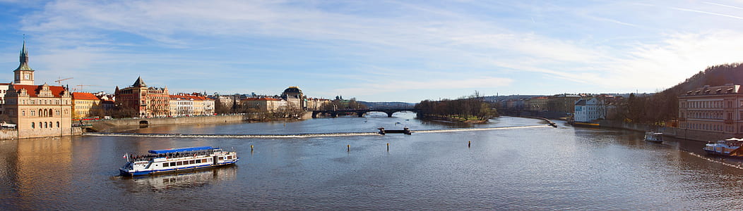 panorama photography of river surrounded by buildings thumbnail