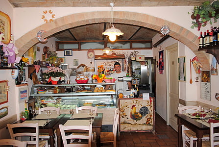 man standing in front of display counter inside restaurant thumbnail
