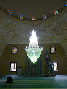 person sitting on stairs inside room with lighted chandelier thumbnail