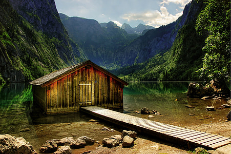 brown wooden cabin house on body of water thumbnail