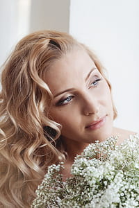 woman looking side way beside baby's breath flowers thumbnail