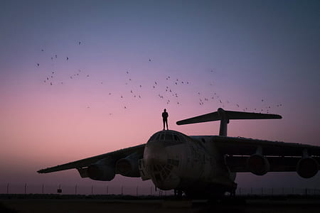 man standing on top of plane thumbnail