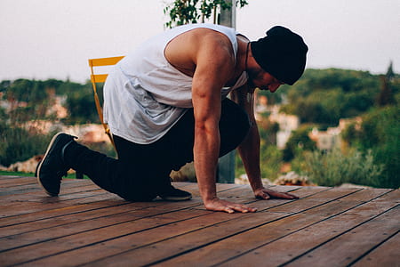 shallow focus photography of man kneeling on ground thumbnail