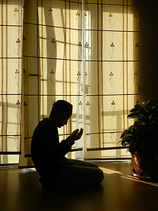 male kneeling on floor beside window thumbnail