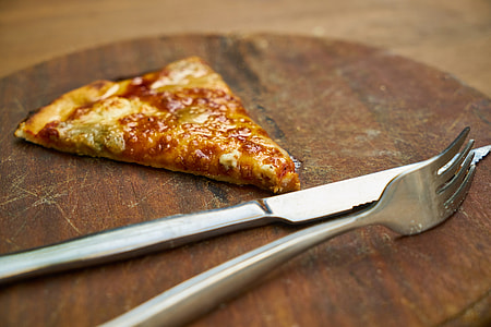 pizza beside fork and knife thumbnail