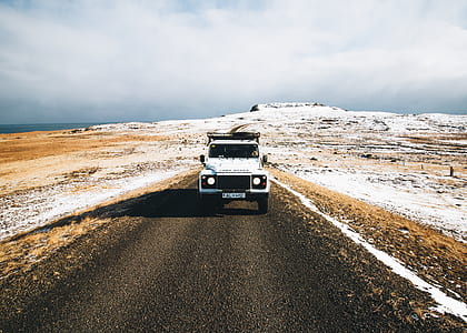 white vehicle in the middle of the field thumbnail