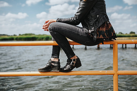 Beautiful blonde woman on a wooden pier by the lake thumbnail
