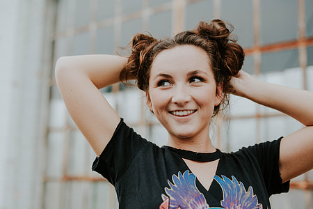 selective focus photography of woman holding her hair thumbnail