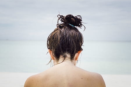 selective focus photography of topless woman facing beach thumbnail