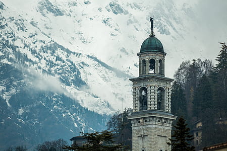 White Concrete Tower Near Mountain thumbnail