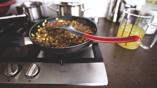 food inside cooking pot with spatula on top thumbnail