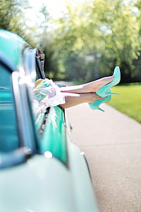 selective focus photograph of person wearing teal pump-heeled shoes thumbnail