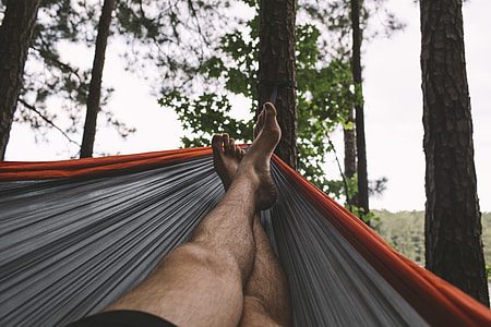 person in black bottoms in hammock raise his feet thumbnail