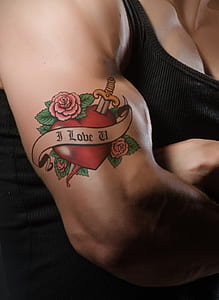 man's forearm with i Love U tattoo thumbnail