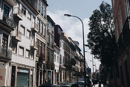 Cars on Road Beside Concrete Buildings thumbnail