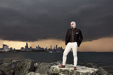 man standing on top of gray rock thumbnail