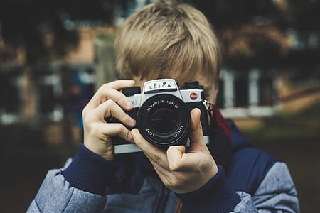 shallow focus photography of man taking a photo in front of camera thumbnail