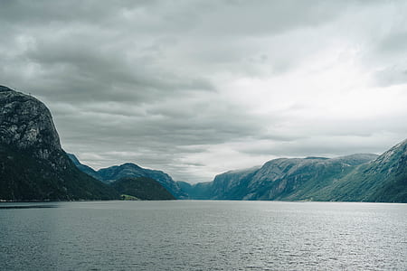 landscape photo of body of water surrounded by mountain thumbnail