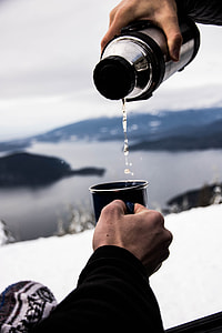 gray stainless steel thermal carafe dropping water on black ceramic mug thumbnail