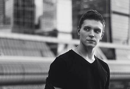grayscale photo of man wearing black shirt thumbnail