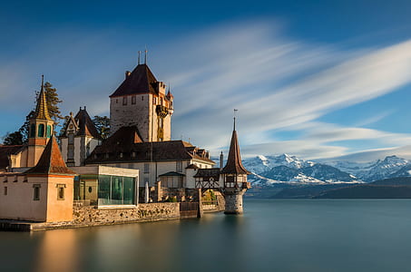 white and brown concrete 2-story building near clear body of water thumbnail