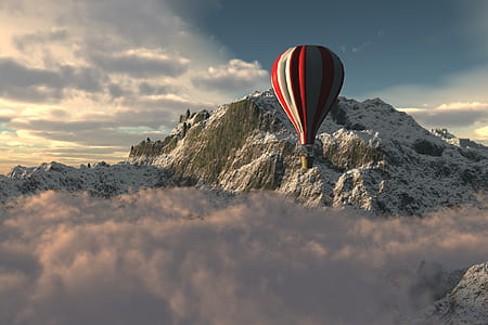 red and white hot air balloon near gray mountain thumbnail