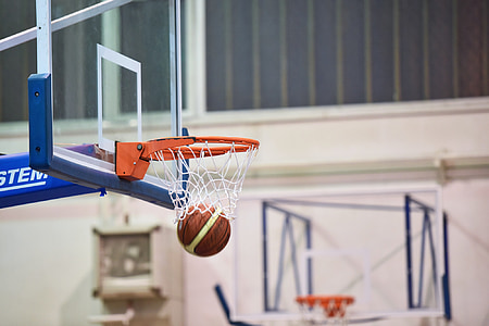 time lapse photo of brown basketball passing through basketball hoop thumbnail