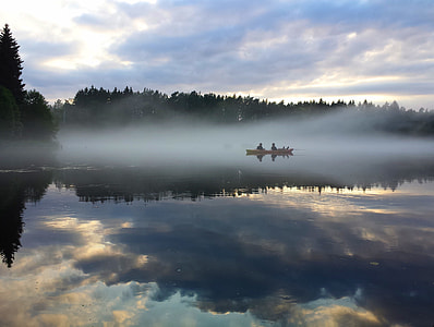 two persons rowing on boat in body of water thumbnail