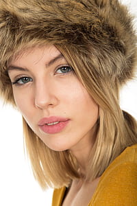 selective focus portrait photography of woman wearing brown fur cap and brown top thumbnail