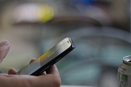 person holding black smartphone thumbnail