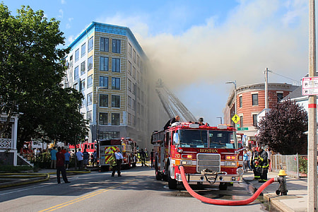 fire truck at the road near the building at daytime thumbnail
