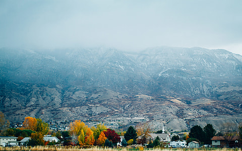 photo of brown and white foggy mountain under cloudy sky thumbnail