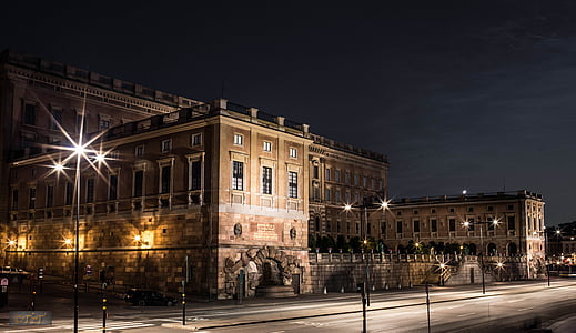 photo of brown stoned building during nighttime thumbnail