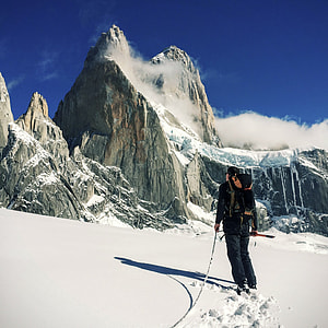 man in black coat on alps mountain thumbnail