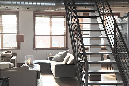gray sofa under gray stair inside room thumbnail