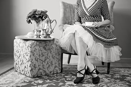 grayscale picture of woman sitting next to end table thumbnail