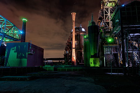 concrete and metal buildings during night thumbnail