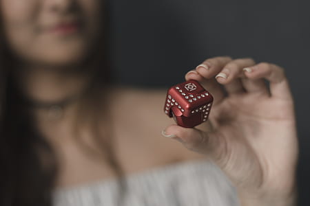 woman holding red die thumbnail